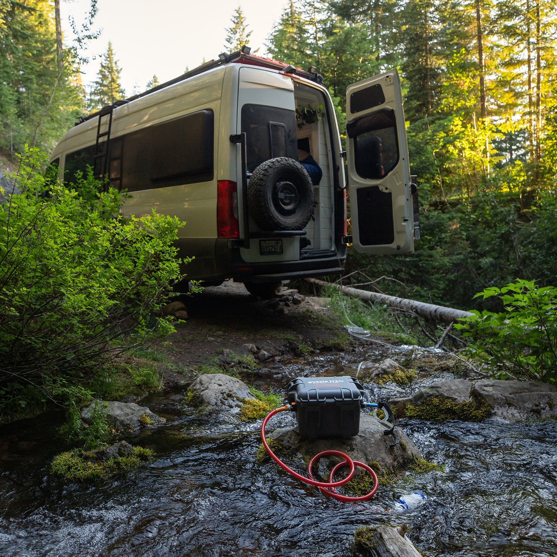 Overland vehicle beside a mountain stream